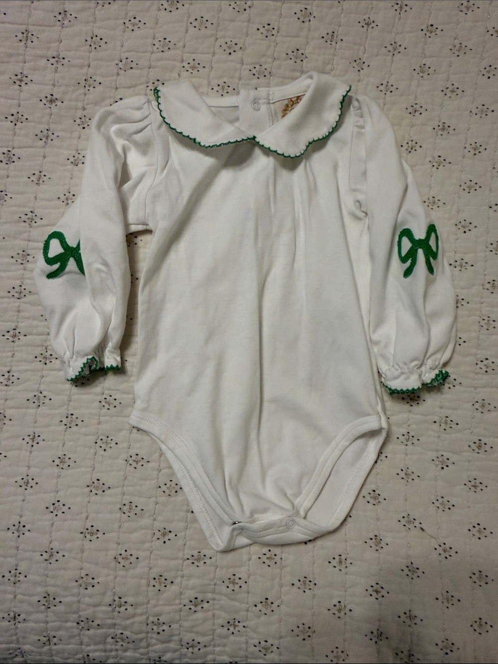 White Long-Sleeve Baby One-Piece with Green Trim and Bow Accents